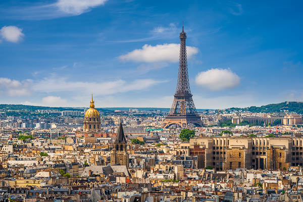 Skyline of Paris, France, with the Eiffel Tower and numerous rooftops in the historic city center by Michael Abid