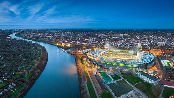 Aerial view of the illuminated Weserstadion in Bremen, Germany, during a home match of Werder Bremen by Michael Abid