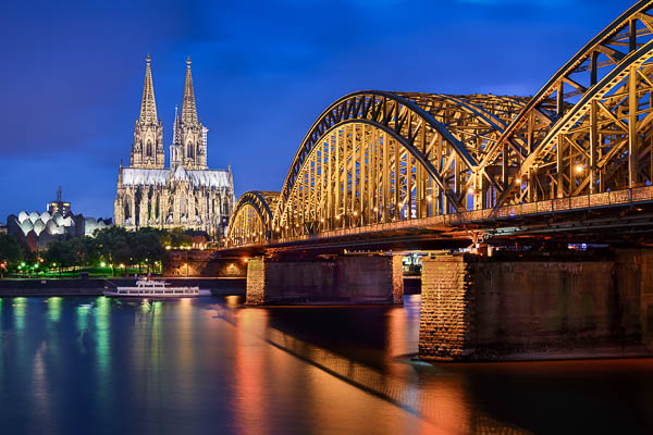 Cathedral and Hohenzollern Bridge at night in Cologne, Germany by Michael Abid