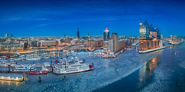 Winter night skyline of Hamburg, Germany with Elbphilharmonie and ice on the Elbe river by Michael Abid