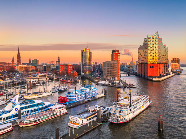 Aerial sunset view of the Elbphilharmonie building in Hamburg, Germany with ships in the harbor and the Elbe river by Michael Abid