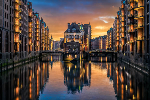 Sunset at the famous Wasserschloss building in the historic Speicherstadt in Hamburg, Germany by Michael Abid