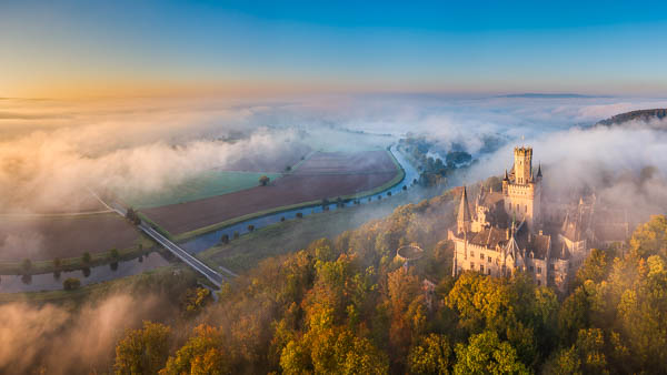 Marienburg Castle near Hannover, Germany on a foggy autumn morning by Michael Abid