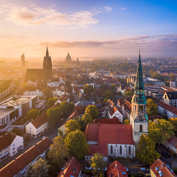 Old town of Hannover, Germany on a foggy autumn morning with the Kreuzkirche church in the foreground and Marktkirche and Town Hall in the background by Michael Abid