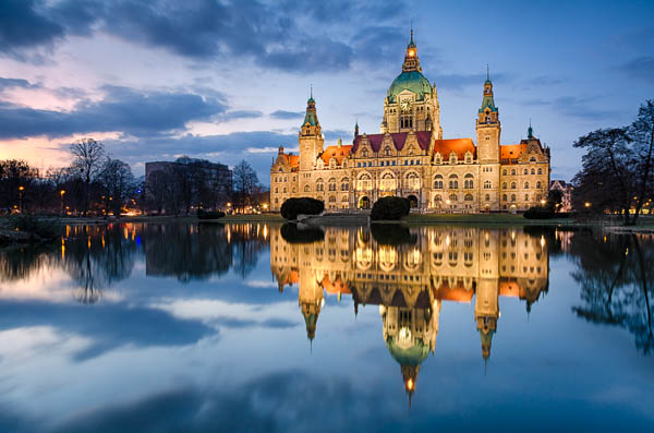 Town Hall of Hannover, Germany at night with reflection in a lake by Michael Abid