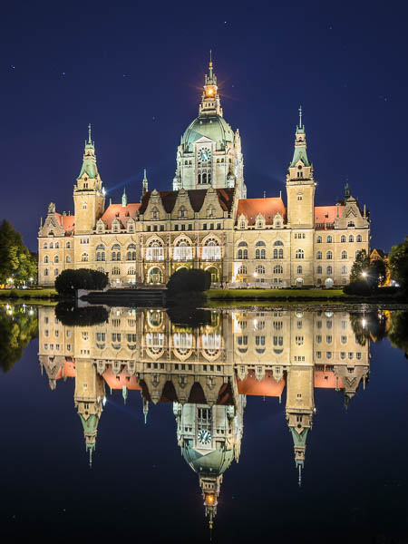 Town Hall of Hannover, Germany at night with reflection in a lake by Michael Abid