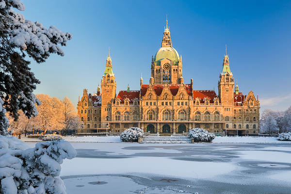 Town Hall of Hannover, Germany in winter with snow and frozen lake by Michael Abid
