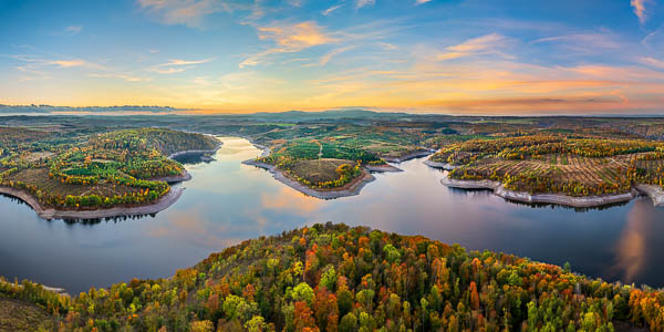 Aerial view of Rotestein in Germany's Harz region, looking across the Rappbode Reservoir toward the Wurmberg and Brocken mountains in the background, taken at sunset by Michael Abid