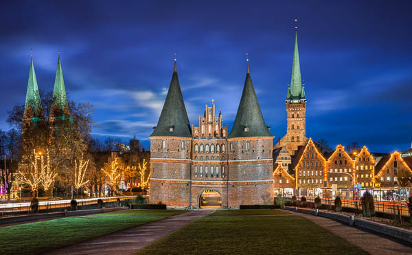 Holstentor in Lubeck, Germany with Christmas decorations by Michael Abid