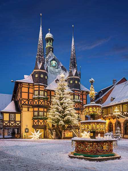Town Hall of Wernigerode, Germany during winter with snow and Christmas decorations by Michael Abid