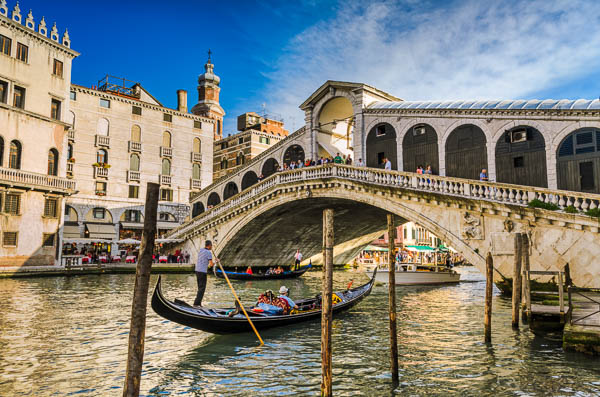 Gondola at the Rialto bridge on a summer evening in Venice, Italy by Michael Abid