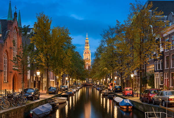 Blick auf eine Kirche und eine Gracht in Amsterdam, Niederlande bei Nacht von Michael Abid