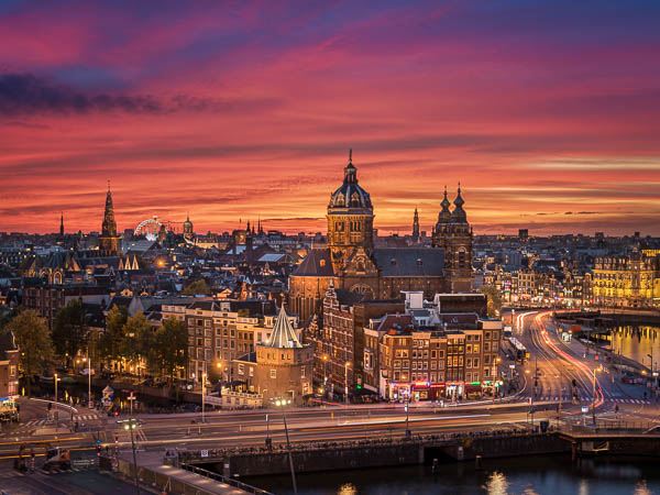 Skyline of the historic city of Amsterdam, Netherlands at sunset by Michael Abid